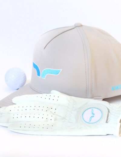 KIKO hat, glove, and golf ball staged on a white background